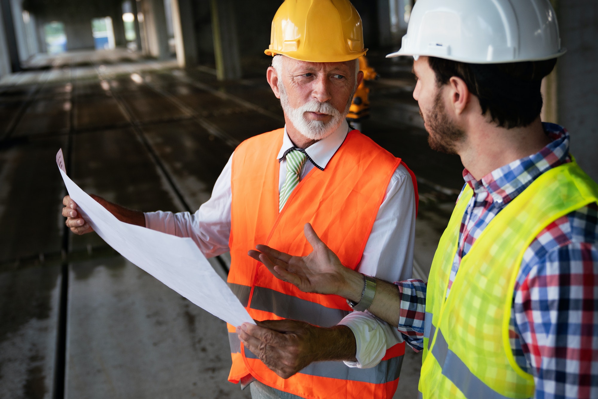 Team of construction engineers, architects working on building site